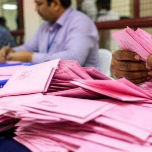 Election officials sorting postal ballots at a vote counting centre in Kerala