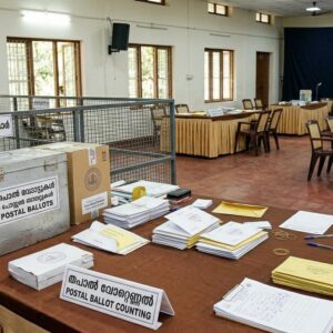 Officials counting postal ballots at an election counting center in Kerala during the early phase of assembly election vote counting.