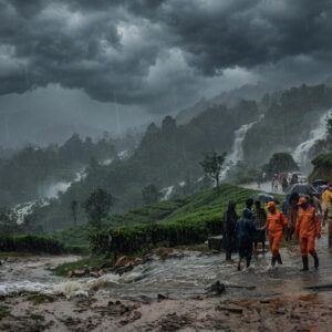 Red Alert issued for Wayanad due to extremely heavy rainfall, with storm clouds over the hills highlighting the risk of landslides and flooding.