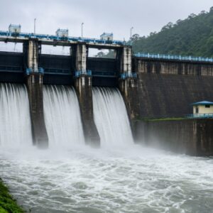 Water being released through the spillway gates of Karapuzha Dam in Wayanad amid monsoon water management operations.