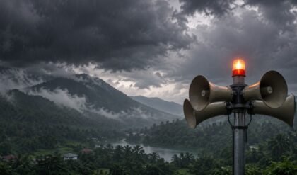 Dark rain clouds over Wayanad with an emergency warning siren symbol representing the Orange Alert in Kerala.